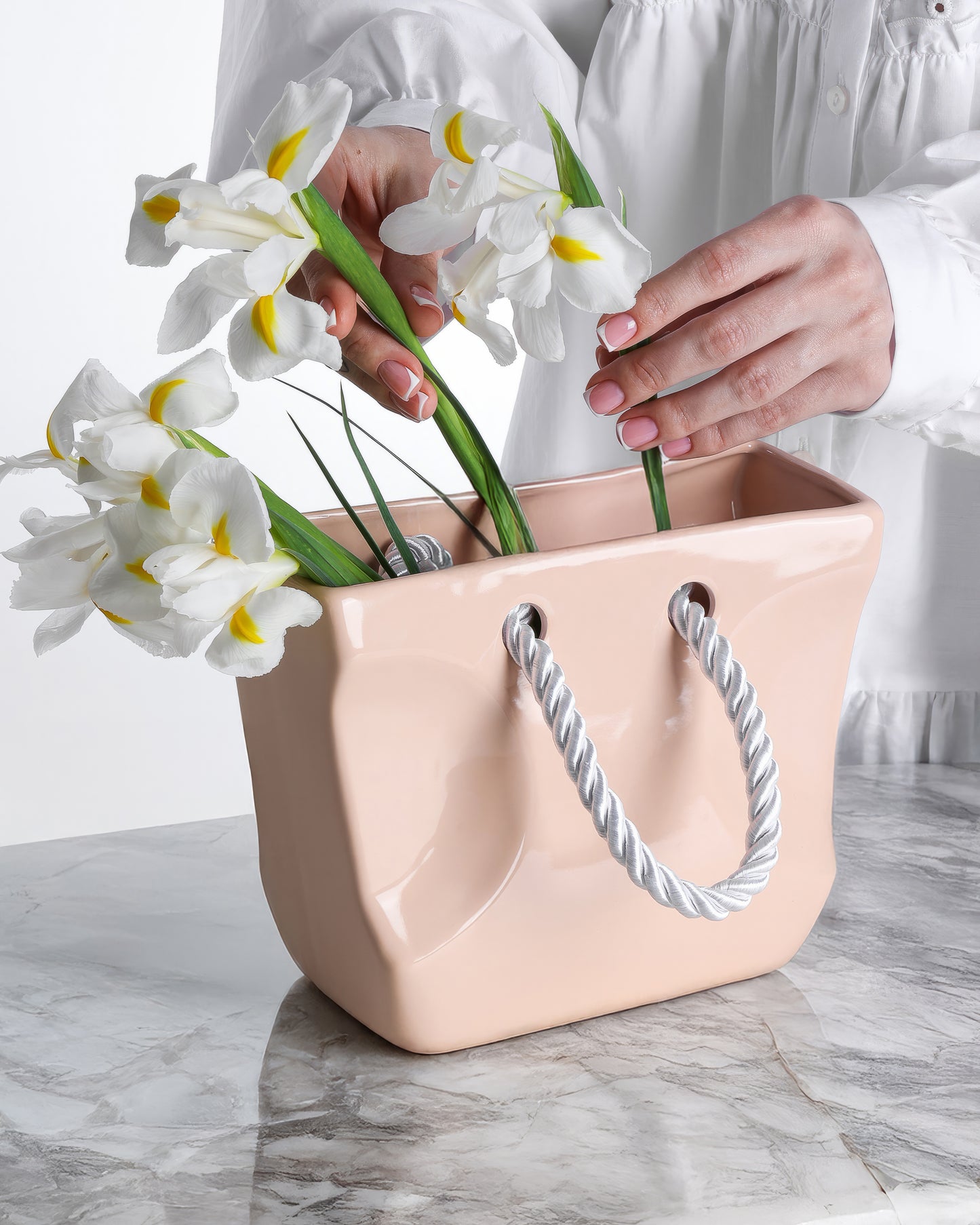 Beige ceramic handbag vase styled with flowers as a neutral gift and home decor accent