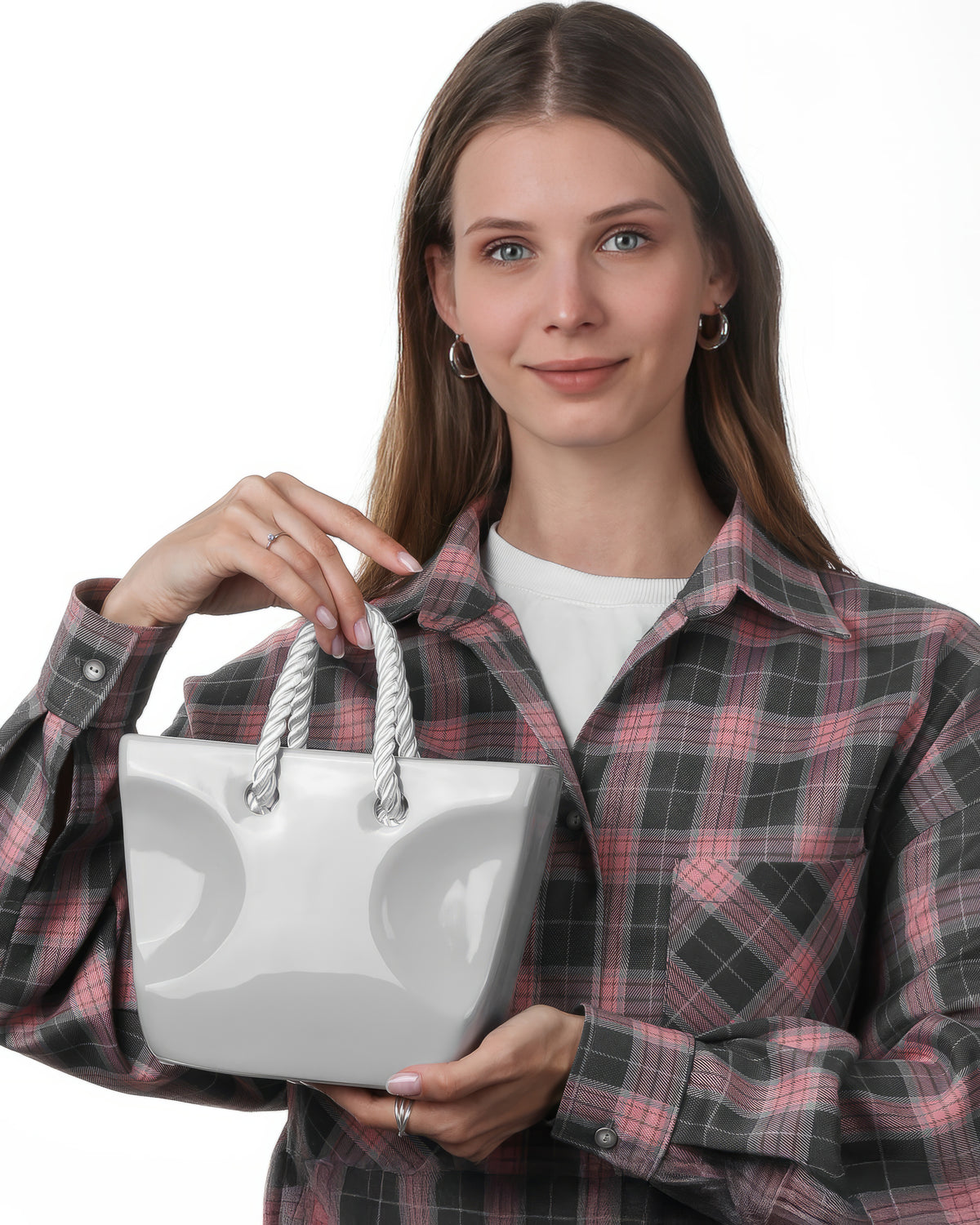 Gray handbag-shaped ceramic vase with rope handles held in hand, minimalist aesthetic flower vase