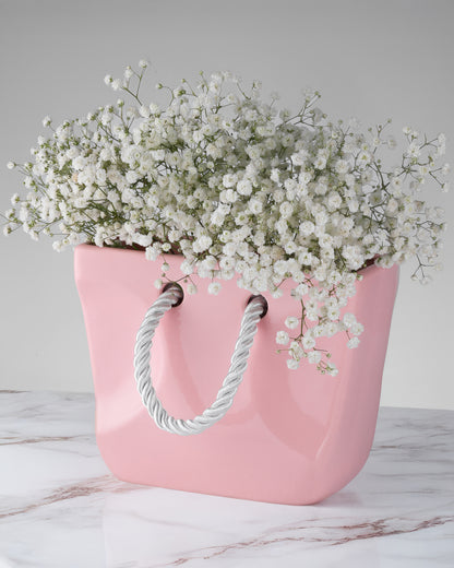 Pink ceramic handbag vase styled with flowers as a bridal shower gift and gift for her