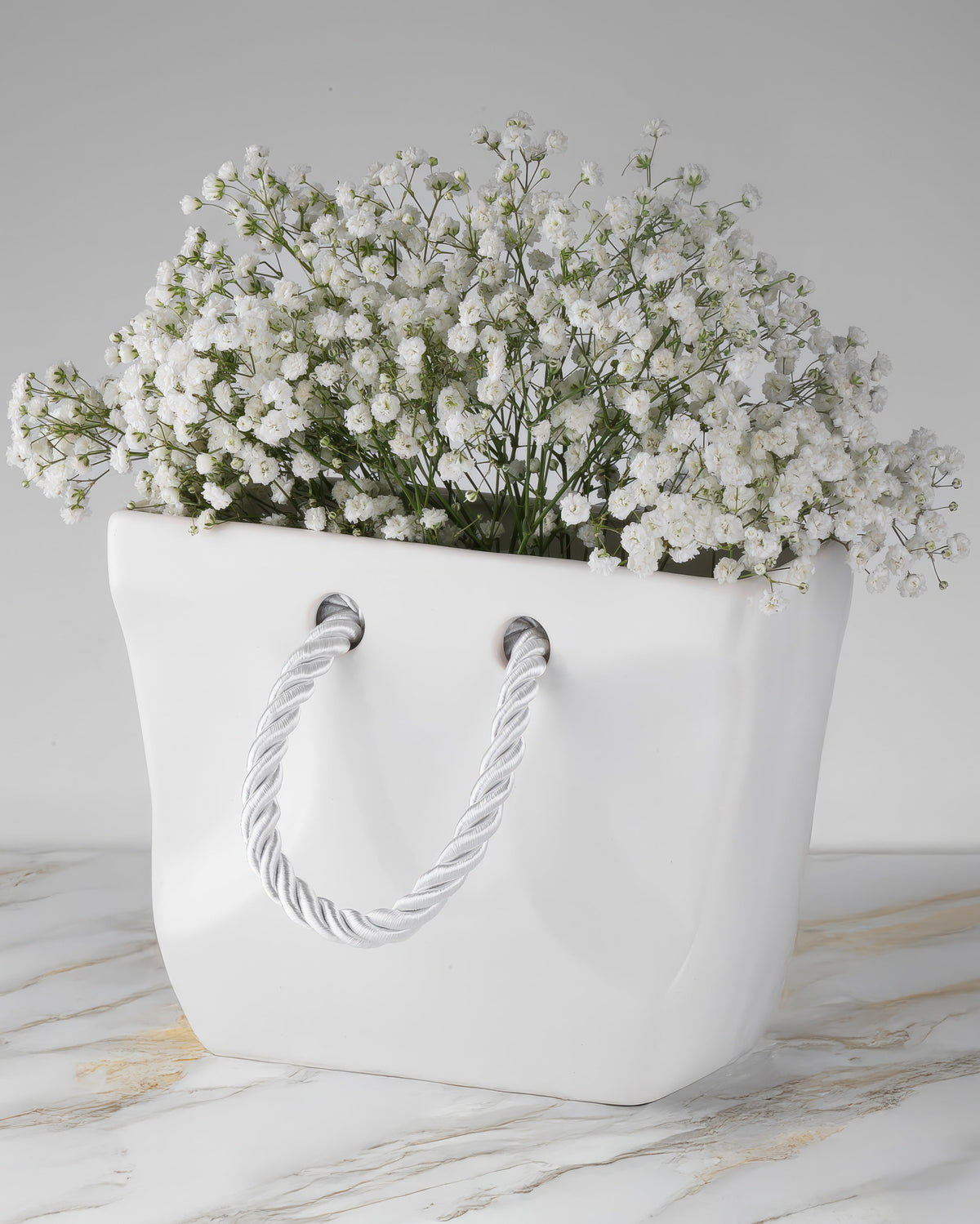 White ceramic handbag vase size 8.7 inches wide and 6.5 inches tall