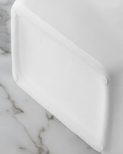 Close-up of the twisted silver rope handles on a glossy white ceramic purse vase