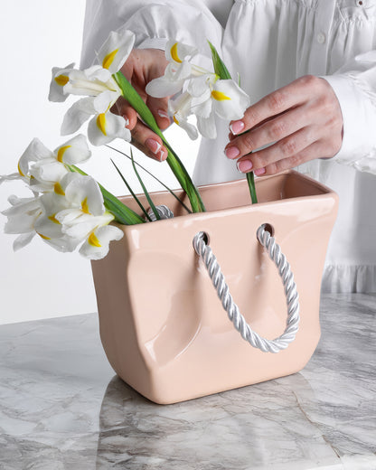 Beige ceramic handbag vase styled with flowers as a neutral gift and home decor accent